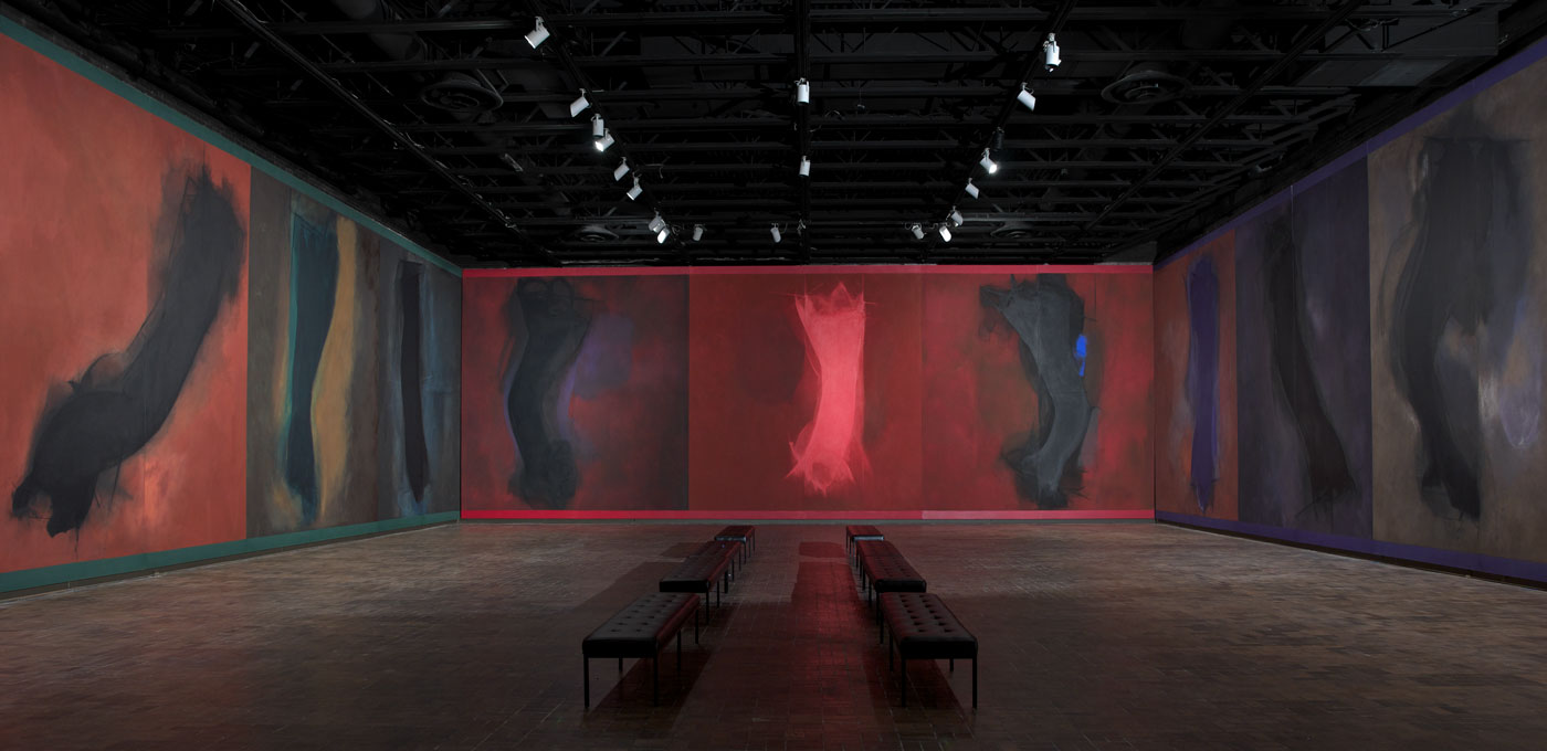 Detail of immersive installation of monumental paintings, each panel with a single abstract form moving across a somber background. This image features the North, East and South walls.